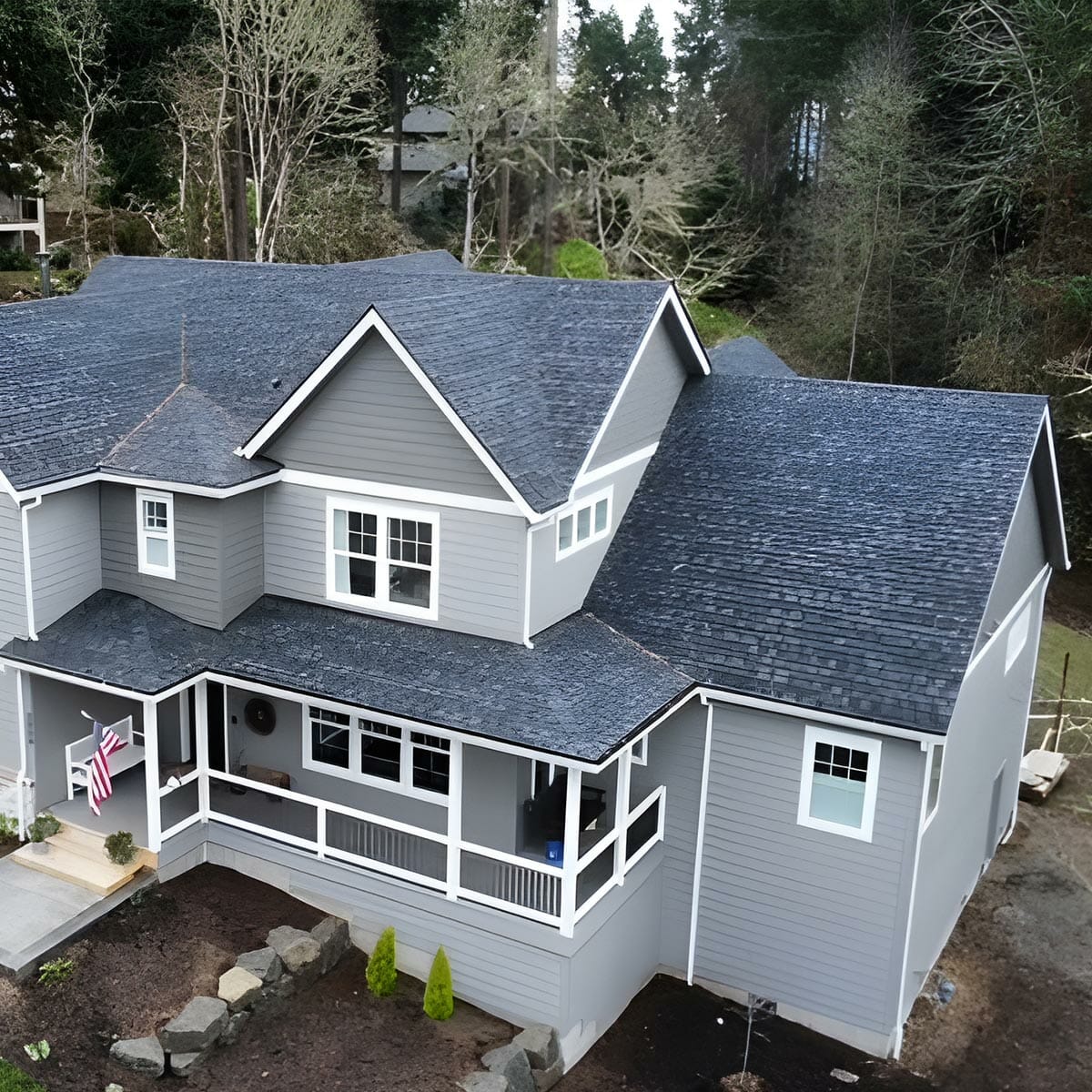 Two-story gray house with charcoal asphalt shingles.